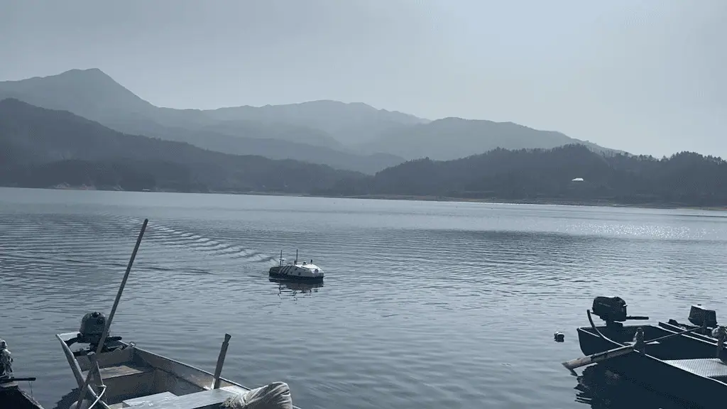 Efficient unmanned Reservoir Survey - image of a USV on a vast reservoir.